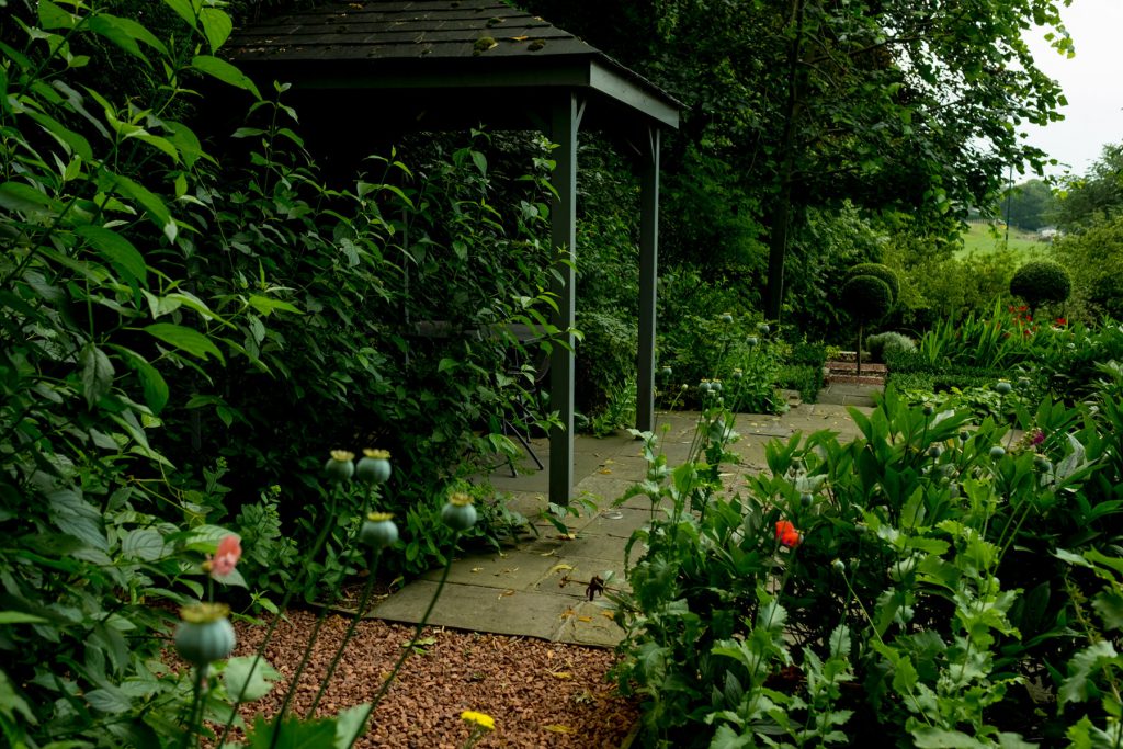 Grey timber pergola in English garden. Harrogate Garden design a